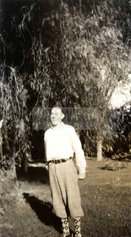 Frank Raymond as a Young Man Standing Under a Tree
