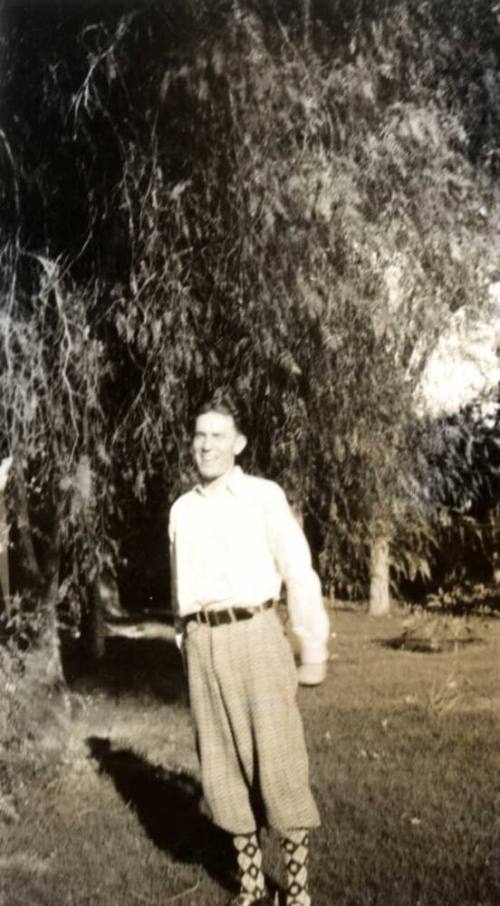 Frank Raymond as a Young Man Standing Under a Tree