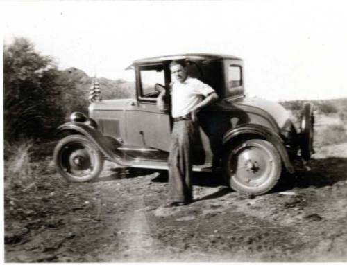 Frank Raymond Posing Infront of a 1920's Car