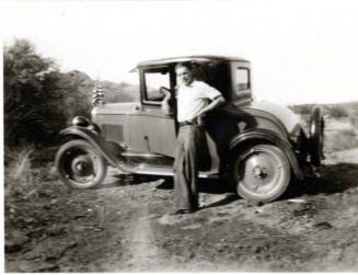 Frank Raymond Posing Infront of a 1920's Car