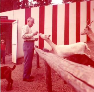Frank Raymond Feeding A Goat