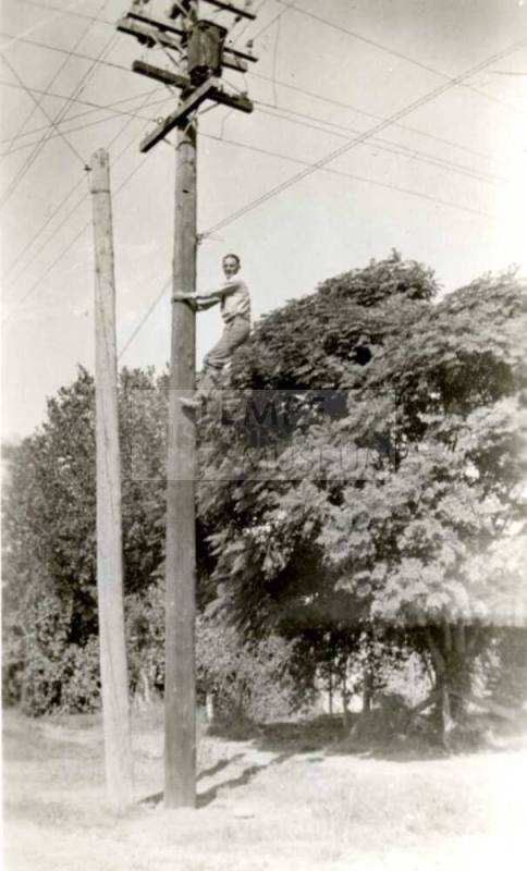 Frank Raymond Climbing Up a Telephone Pole