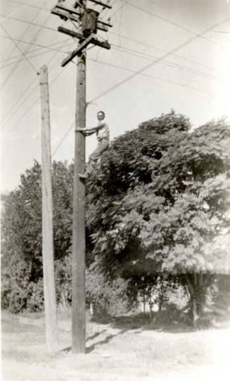 Frank Raymond Climbing Up a Telephone Pole