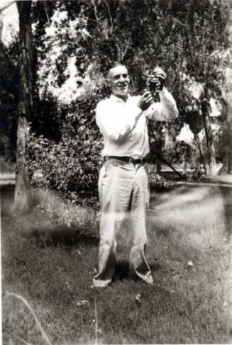 Frank Raymond Holding a Bunch of Grapes
