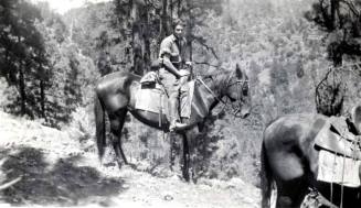 Man in Military Clothing on Horseback in a mountainous, wooded region