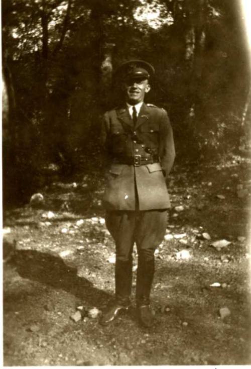 Frank Raymond Standing Under Trees in His Military Uniform