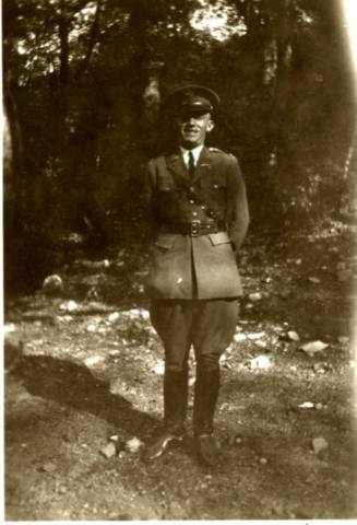 Frank Raymond Standing Under Trees in His Military Uniform