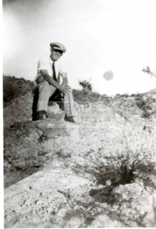 Frank Raymond Sitting on Rocks in the Desert