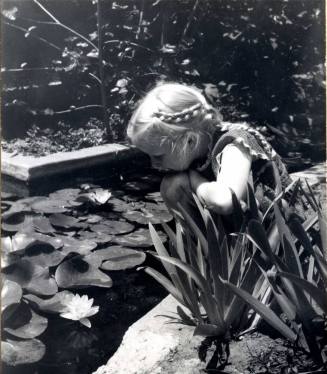 Young Girl Looking into a Pond