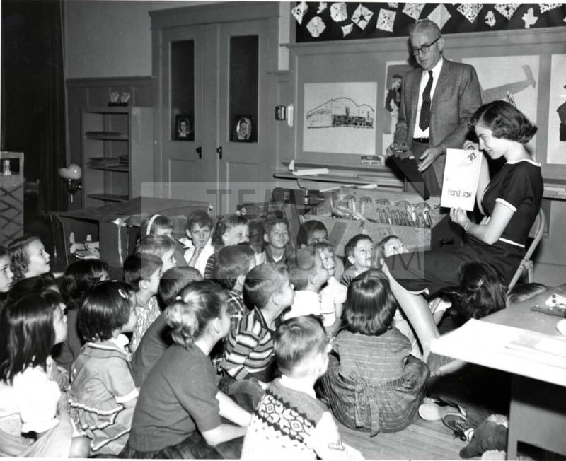 Young Teacher Teaching her Kindergarten Class about Tools