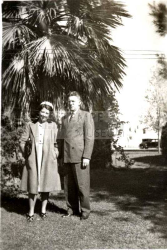 Minnie and Frank Raymond Standing on a Lawn