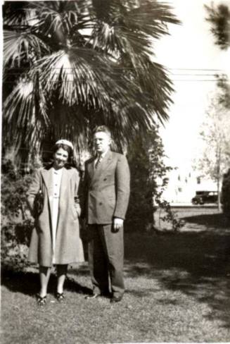 Minnie and Frank Raymond Standing on a Lawn