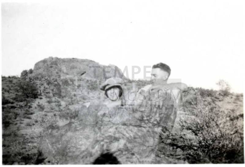 Minnie Laird and Frank Raymond Pose Behind a Rock Formation