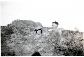 Minnie Laird and Frank Raymond Pose Behind a Rock Formation