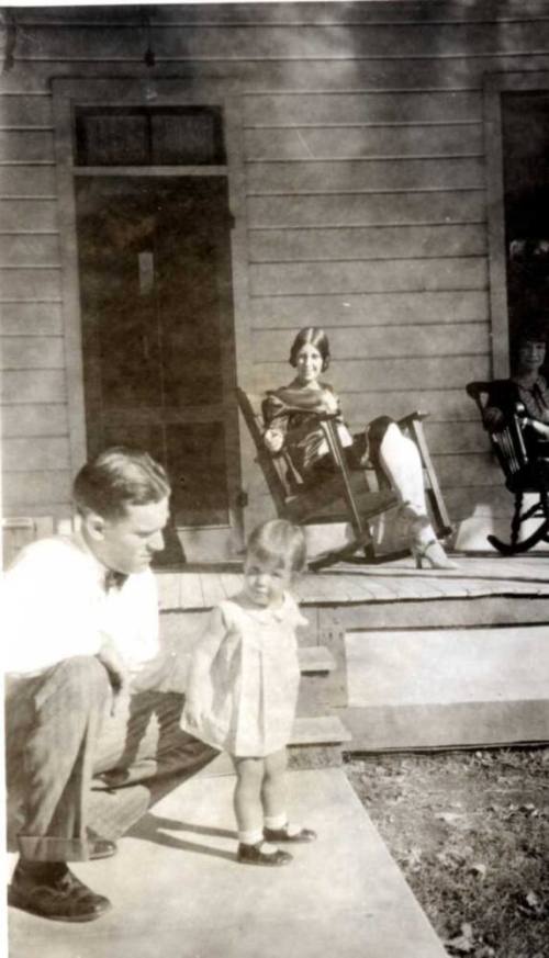 Frank Raymond Kneels next to Little Girl