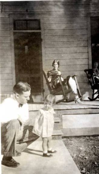Frank Raymond Kneels next to Little Girl