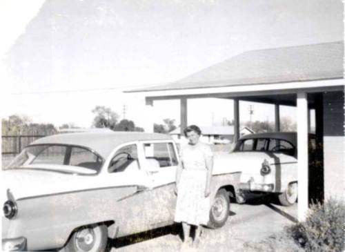 Minnie Raymond Standing Next to Car