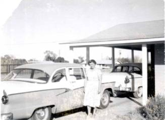 Minnie Raymond Standing Next to Car
