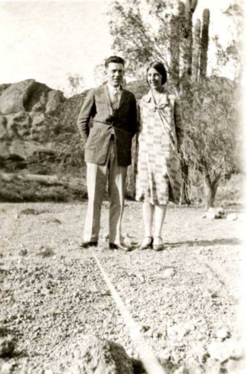 Frank and Minnie Raymond Standing in Front of Cactus