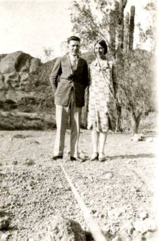 Frank and Minnie Raymond Standing in Front of Cactus