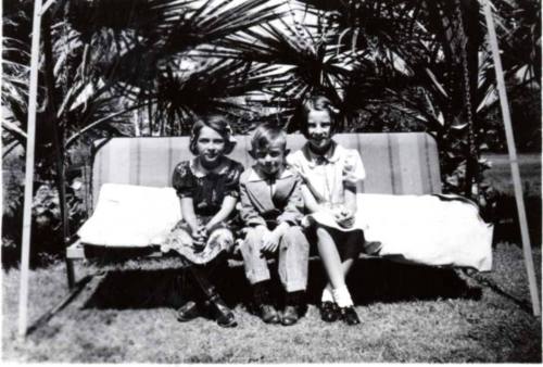 Joann Dewey, Bill and JoAnn Raymond on a Swing