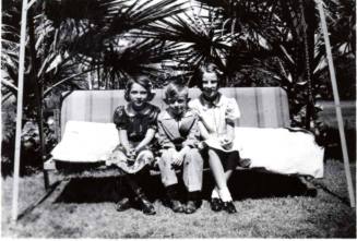 Joann Dewey, Bill and JoAnn Raymond on a Swing