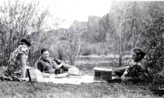 Minnie, Frank, and John Raymond Enjoy a Picnic Outdoors