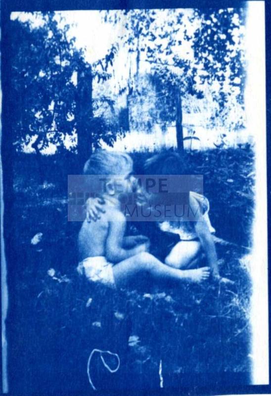 Joann and Bill Raymond Sit Together on a Lawn