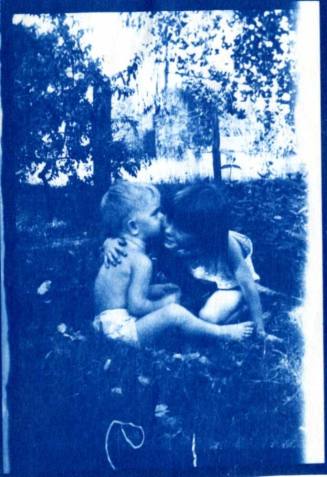 Joann and Bill Raymond Sit Together on a Lawn
