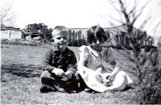 Bill and Joann Raymond Sit Nicely on a Lawn