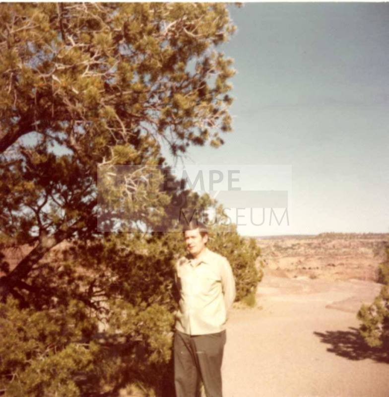 Bill Raymond Poses Outdoors Near a Tree