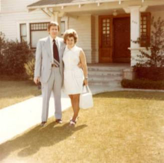 William Raymond Stands Outside a House with a Woman