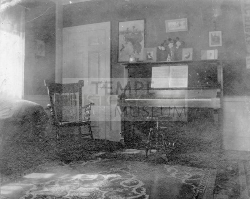 Interior showing Rocking Chair and Piano with photographs on wall