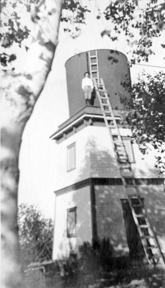 Niels Petersen's nephew on water tower northwest of kitchen.