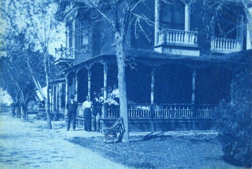 Petersen house with family standing at corner
