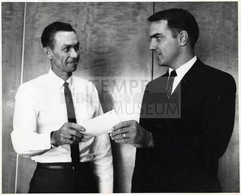 Photograph - 2 Men Exchanging Document