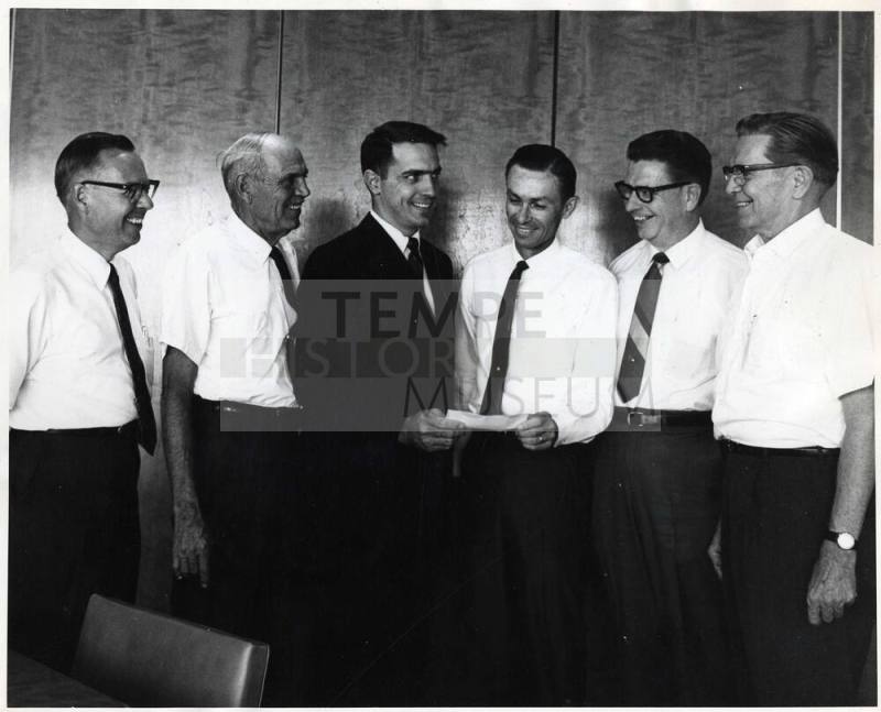 Photograph - 6 Men Gathered Exchanging Document