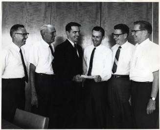Photograph - 6 Men Gathered Exchanging Document