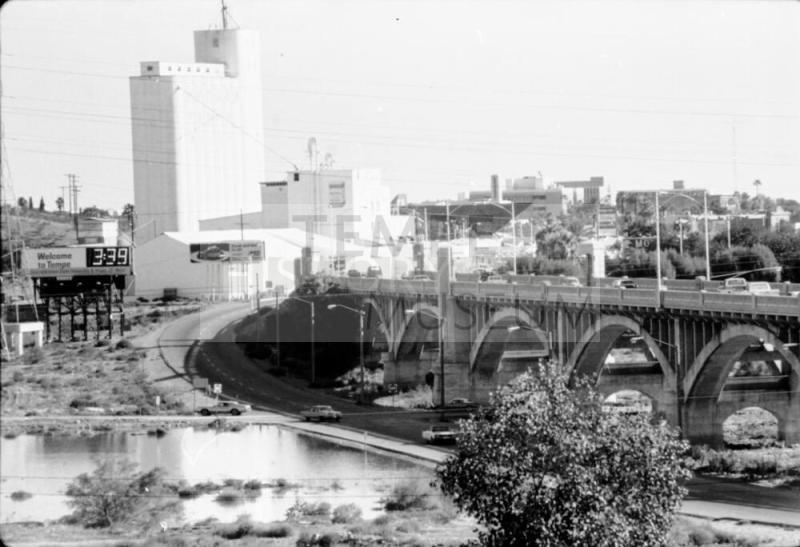 Looking south across Salt River at Hayden Flour Mill, Mill Avenue bridge on right, and roadway through riverbed in lower center