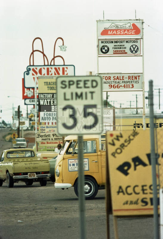 Signs for businesses along Scottsdale Road, including Michelle's Massage, Modern Import Motors, and Scene West.