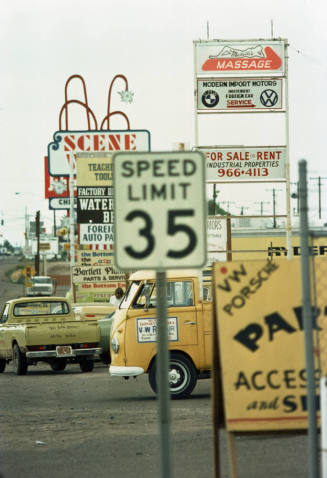 Signs for businesses along Scottsdale Road, including Michelle's Massage, Modern Import Motors, and Scene West.