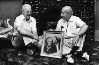 Photo of the Carr Brothers in a Carr Home with their parent’s picture