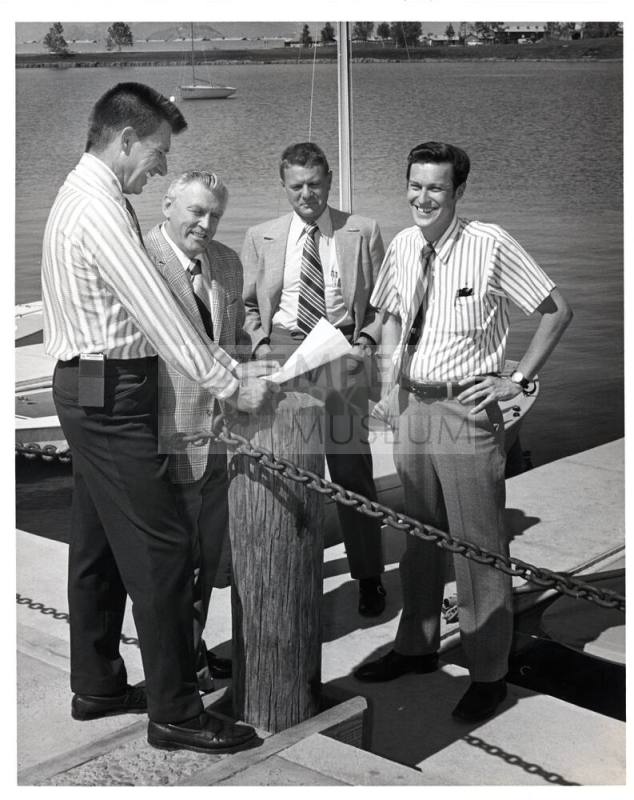 Group of Men at Dock by Lake