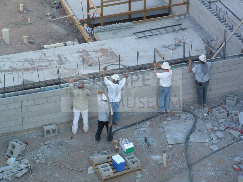 Tempe Center for the Arts construction photograph-Workers Filling Cinderblock Wall with Concrete