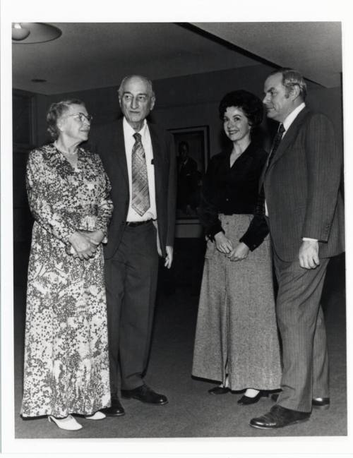 Two couples in campus building