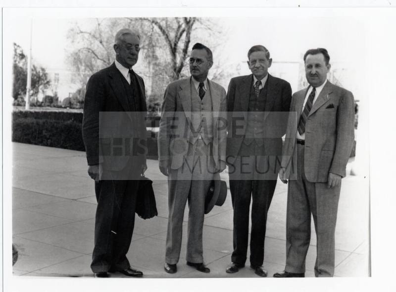 Group of four men on campus
