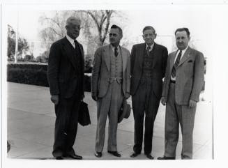 Group of four men on campus