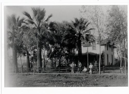 Family in front of two-story house