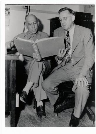 Two men looking at a book