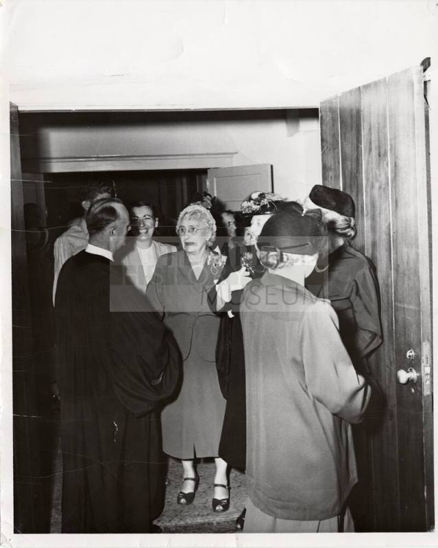Photograph of  Reverend Prior greeting parishiners in doorway of First Congregational Church of Tempe